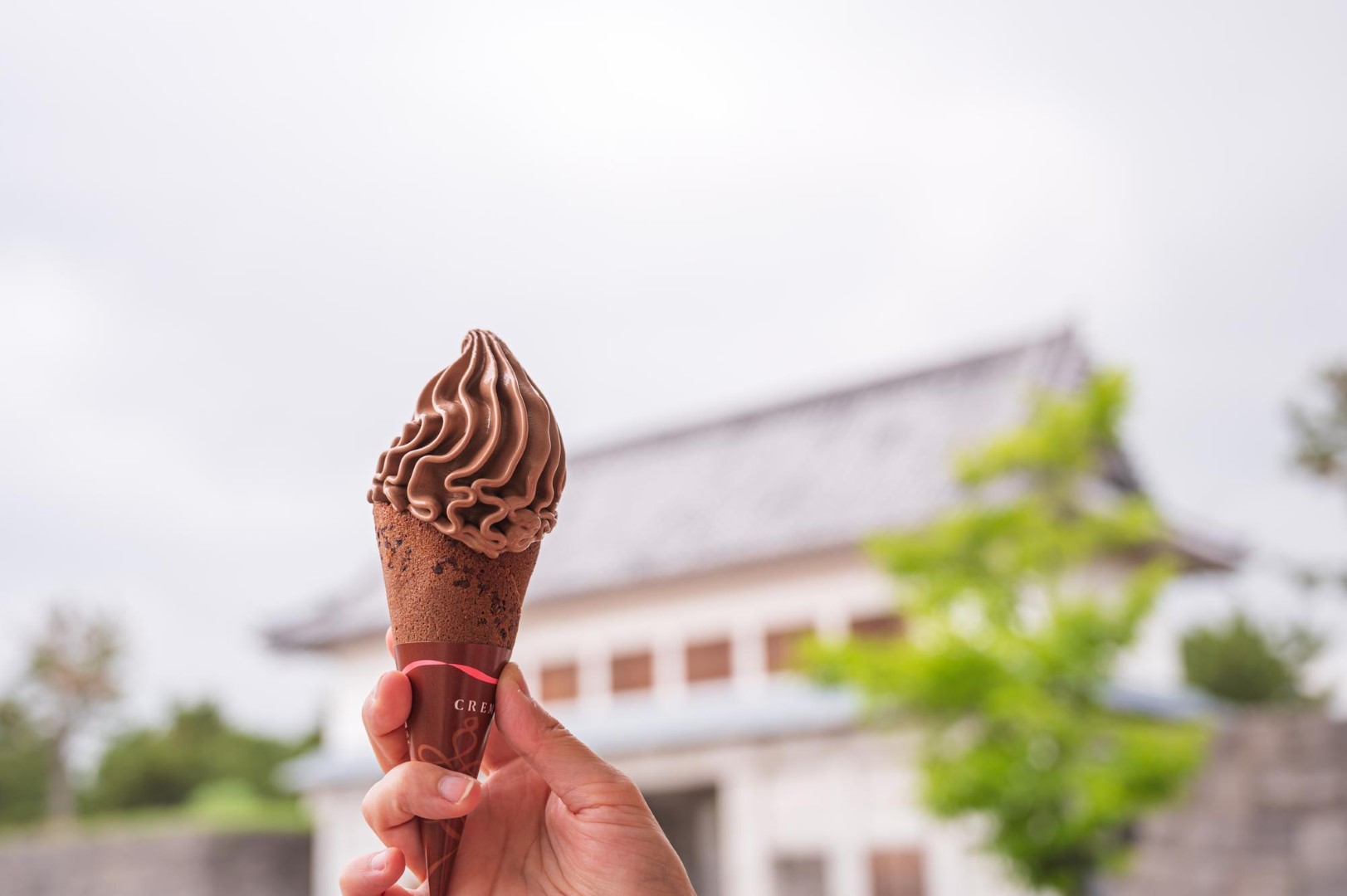 chocolate soft serve Woman outdoor at summer sunset time having ice cream cone positive happy playful at city street