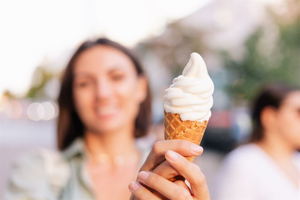 Caramel-Butterscotch-melted-liquid-1024x683 Woman outdoor at summer sunset time having ice cream cone positive happy playful at city street